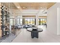 Open living space with a glass-enclosed wine room, tile floors, wood ceilings and mountain views at 10641 E Blue Sky Dr, Scottsdale, AZ 85262