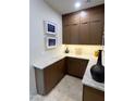 Hallway features lots of custom wood storage, artistic pictures, and marble counters at 10821 E Troon North Dr, Scottsdale, AZ 85262