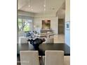 Open-concept living room with a large window, modern decor, and plenty of natural light at 10821 E Troon North Dr, Scottsdale, AZ 85262