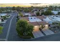 Aerial view showcasing a quiet neighborhood with beautiful homes, mature trees, well-maintained roads, and mountain views at 11416 N Century Ln, Scottsdale, AZ 85254