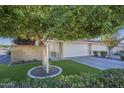 House featuring a private gated entry, two car garage and well-maintained lawn with mature landscaping at 11416 N Century Ln, Scottsdale, AZ 85254