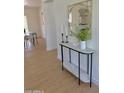 Stylish entryway featuring a marble console table with decorative mirror, candles, and greenery, adding elegance at 1421 W Pasadena Ave, Phoenix, AZ 85013