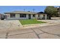 Well-maintained single-story home featuring a manicured lawn and a clean, painted exterior at 1421 W Pasadena Ave, Phoenix, AZ 85013