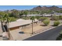 Spacious home featuring a tile roof, a large driveway, and palm trees at 1530 E Loma Ln, Phoenix, AZ 85020