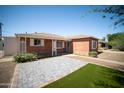 Charming brick home featuring updated landscaping and a well-manicured front yard at 1721 W Earll Dr, Phoenix, AZ 85015