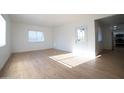 Bright living room with new vinyl floors, fresh white paint, and abundant natural light at 1721 W Earll Dr, Phoenix, AZ 85015