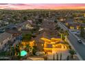 Aerial view of a charming neighborhood with a home featuring a private pool and lush landscaping at 21575 E Twin Acres Ct, Queen Creek, AZ 85142