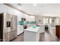 View of the kitchen with stainless steel appliances, a center island, and stone countertops at 2511 W Queen Creek Rd # 258, Chandler, AZ 85248