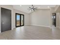 Spacious bedroom with tile floors and access to a private balcony with scenic views at 25846 W Denver Hill Dr, Wittmann, AZ 85361