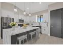 Modern kitchen features a large island, stainless steel appliances, and ample white and gray cabinetry at 25846 W Denver Hill Dr, Wittmann, AZ 85361
