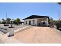 Cozy home showcasing a covered carport, desert landscaping, and a charming walkway to the entrance at 2815 W Ohio St, Apache Junction, AZ 85120
