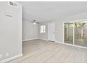 Living room features wood-look floors, neutral paint, and sliding glass doors at 286 W Palomino Dr # 147, Chandler, AZ 85225