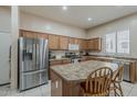 Well-equipped kitchen features stainless steel appliances, a center island, and ample cabinet space for storage at 2976 E Clifton Ave, Gilbert, AZ 85295