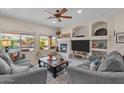 Bright living room with backyard view, fireplace, built-in shelves, and comfortable seating, creating a cozy atmosphere at 3018 E Vernon St, Gilbert, AZ 85298