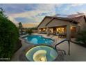 Stunning backyard oasis features a private pool, spa, covered patio, and lush landscaping, perfect for entertaining at 3018 E Vernon St, Gilbert, AZ 85298
