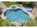 Aerial view of the sparkling pool and spa area with waterfall feature and sun loungers at 31259 N 42Nd Pl, Cave Creek, AZ 85331