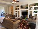 Spacious living room with built-in shelving, plush furniture, and a warm, inviting atmosphere at 35401 N Via Tramonto St, Phoenix, AZ 85086