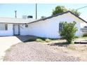 Well-kept single-Gathering home with a white exterior, tidy yard and two-car garage at 3651 W Mariposa St, Phoenix, AZ 85019