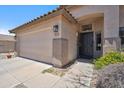Charming home featuring a two-car garage, a stylish black front door, and vibrant desert landscaping at 4440 E Tether Trl, Phoenix, AZ 85050