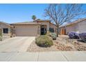 Inviting single-story home with a well-maintained desert landscape, a spacious driveway, and a two-car garage at 4440 E Tether Trl, Phoenix, AZ 85050