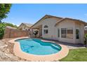 Private pool with poolside landscaping and serene backyard, creating a refreshing outdoor space at 4440 E Tether Trl, Phoenix, AZ 85050