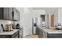 Modern kitchen featuring stainless steel appliances and sleek black cabinetry at 5496 E Axle Ln, San Tan Valley, AZ 85140