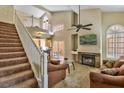 Cozy living room showcases a staircase, fireplace, comfortable seating, and access to the kitchen at 5640 E Bell Rd # 1034, Scottsdale, AZ 85254