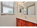 Bright bathroom featuring a vanity with a mirror and a window for natural light at 6843 S 9Th Ave, Phoenix, AZ 85041