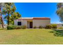 Inviting single-level home with a manicured lawn, tidy landscaping, and a cozy feel at 7802 E Rovey Ave, Scottsdale, AZ 85250