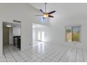 Bright living room with vaulted ceiling, tiled floor, and access to the backyard at 7802 E Rovey Ave, Scottsdale, AZ 85250