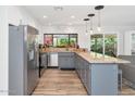 Bright kitchen featuring an island, stainless steel appliances, views to the backyard, and tiled floors at 7806 N Via Del Sol --, Scottsdale, AZ 85258