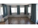 Inviting living room featuring stylish wood flooring and ample natural light from several windows at 7807 E Main St # D-26, Mesa, AZ 85207