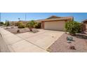 Well-maintained brick home with desert landscaping and a spacious driveway leading to a two-car garage at 7839 E Milagro Ave, Mesa, AZ 85209