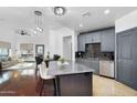 Modern kitchen with stainless steel appliances, a gray kitchen island, and dark wood flooring at 945 E Playa Del Norte Dr # 4019, Tempe, AZ 85288