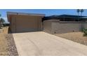 A well-maintained garage with a driveway leading up to it, complemented by desert landscaping at 9708 W Redwood Dr, Sun City, AZ 85351
