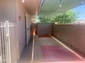 Inviting covered patio space with privacy wall, perfect for outdoor entertaining and relaxation at 9708 W Redwood Dr, Sun City, AZ 85351