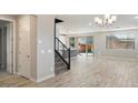 Bright living room featuring hardwood floors, large windows, and modern lighting at 10013 E Trent Ave, Mesa, AZ 85212