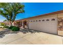 Home exterior featuring desert landscaping and a two-car garage in a sunny neighborhood at 11360 E Keats Ave # 92, Mesa, AZ 85209