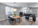 Bright living and dining area with stylish furnishings and neutral tones offering a comfortable living space at 12211 W Hide Trl, Peoria, AZ 85383