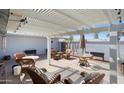 Comfortable outdoor patio featuring wicker furniture, a lattice-covered pergola, and a barbeque grill at 12826 W Maplewood Dr, Sun City West, AZ 85375