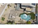 Aerial view showcasing a backyard oasis with a pool, pergola, and lush landscaping at 13160 W Windsor Ave, Goodyear, AZ 85395