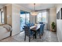 Elegant dining room with stylish chairs, chandelier lighting, and access to the backyard at 13237 W Redstone Dr, Peoria, AZ 85383
