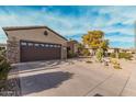 View of home featuring a garage and desert landscaping in the front yard at 15452 W Skyview Way, Surprise, AZ 85374