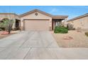 Well-maintained single-story home featuring desert landscaping, a large driveway, and an attached two-car garage at 15634 S 31St St, Phoenix, AZ 85048