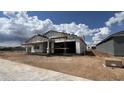 New construction home with scaffolding, hinting at a modern design in a developing neighborhood at 15794 W Cheryl Dr, Waddell, AZ 85355