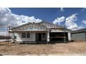 New home with scaffolding in the building phase, presenting a modern and spacious design at 15794 W Cheryl Dr, Waddell, AZ 85355
