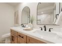 Bathroom featuring a double sink vanity, arched mirrors, and modern black fixtures at 1609 W Yukon Dr, Phoenix, AZ 85027