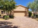 Desert home featuring a spacious two-car garage with a brick driveway and mature landscaping at 16538 E Westwind Ct # 51, Fountain Hills, AZ 85268