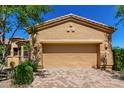 View of the garage, with its tan stucco and matching garage door, complementing the home's exterior at 16538 E Westwind Ct # 51, Fountain Hills, AZ 85268