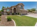 Charming home featuring a well-maintained lawn, mature landscaping, and a two-car garage at 1705 W Lark Dr, Chandler, AZ 85286